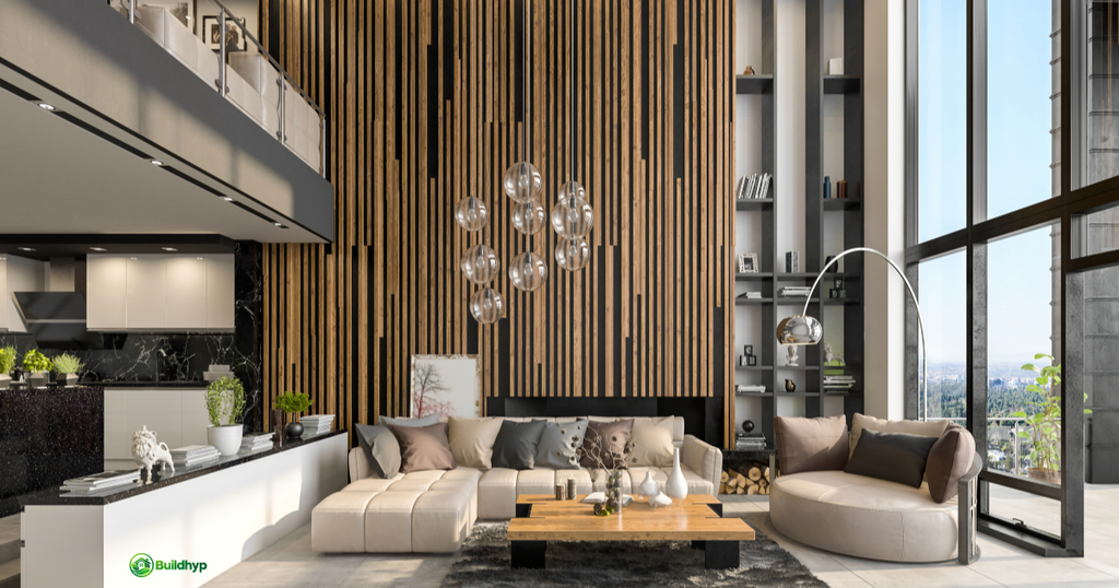 Modern Summit Tiny Homes interior features a floor-to-ceiling wood slat wall, hanging globe lights, beige sectional sofa, open kitchen, and tall glass windows. 