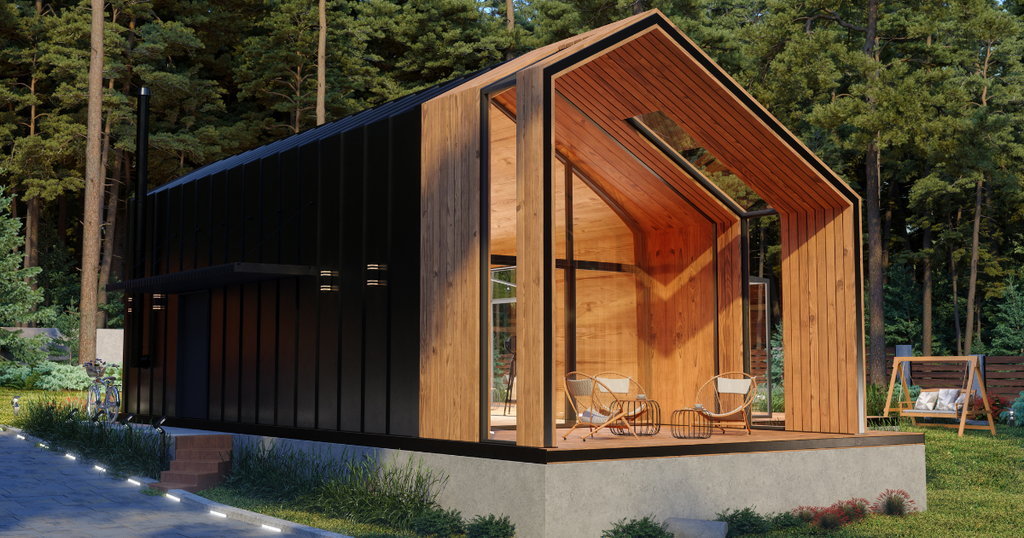 A tiny home features a striking contrast between its black metal exterior and a warm cedar-clad A-frame facade. A covered deck holds chairs, a table, and a swing.